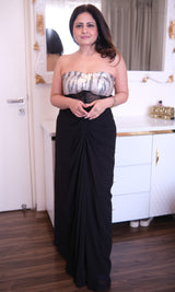 Black georgette drape knot skirt paired with a sequined off-shoulder top.
